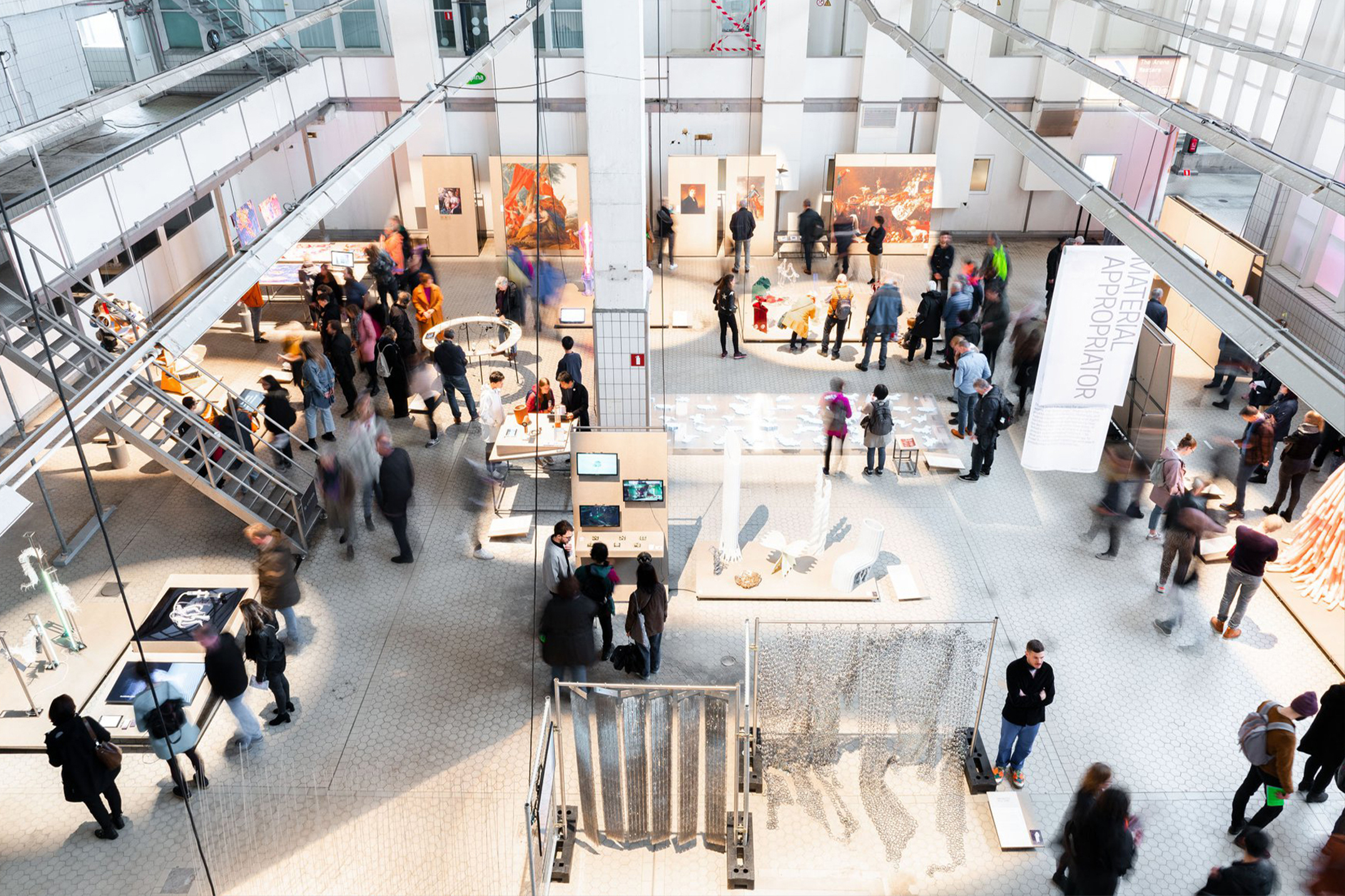 Aerial view of visitors browsing exhibition installations at the DAE graduation show